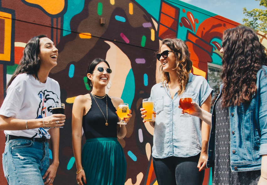 A group of women holding drinks